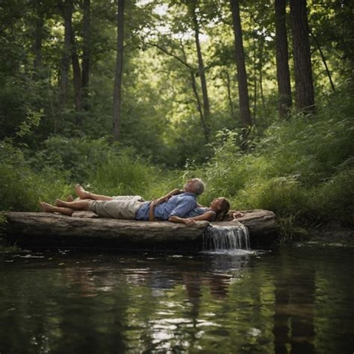 a man and woman laying on top of a bed next to each other with their
