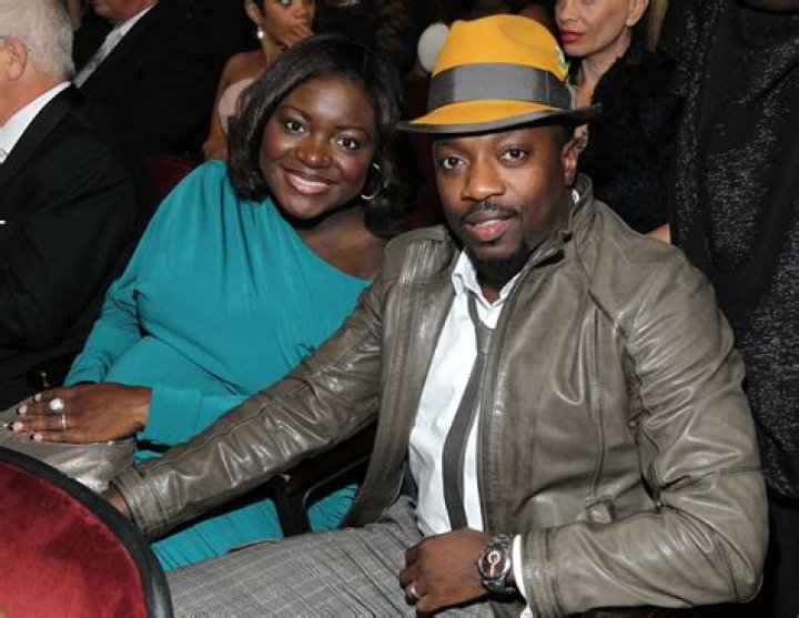 Anthony Hamilton and his wife Linda walk through the paddock Formula