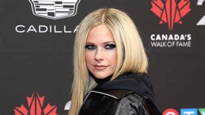 Avril Lavigne sports asymmetrical mini skirt with the tiniest new