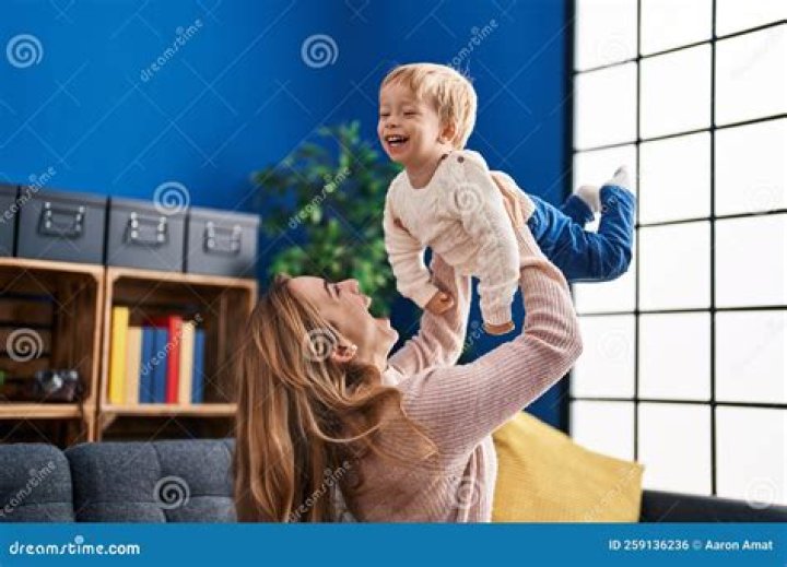 mother and son holding shopping paper bag with groceries customers