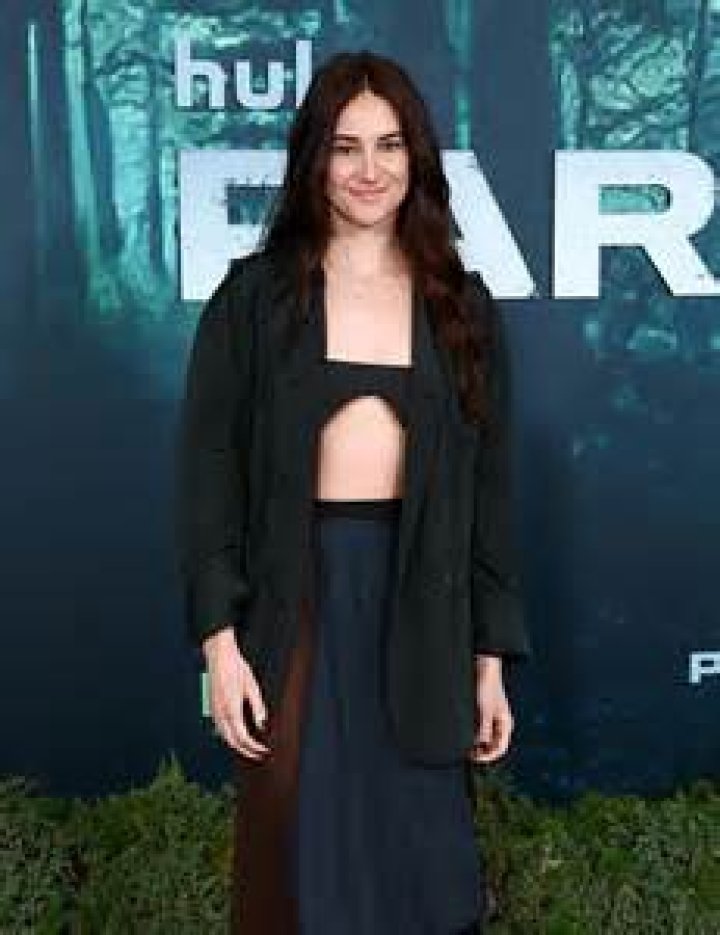 Shailene Woodley wears a prosthetic baby bump beneath her red dress as
